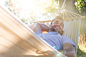 Young man relaxing in summer hammock