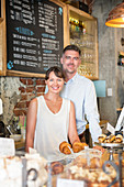 Cafe owner couple behind the counter