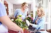 Florist helping woman pick out flowers