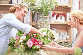 Florist arranging bouquet for customer