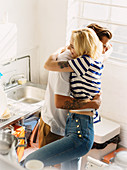 Young couple hugging in apartment kitchen