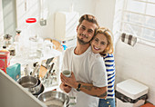 Young couple hugging in apartment kitchen