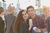 Portrait smiling young couple drinking