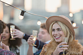 Smiling Woman drinking champagne at party
