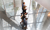 Business people walking in modern lobby