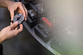 Worker examining part in steel factory