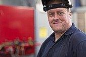 Portrait confident welder in factory