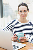 Portrait confident woman drinking coffee
