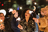 Young women waving sparklers