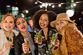 Women drinking cocktails at party