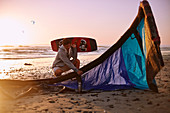 Man with kiteboarding equipment