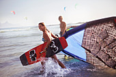 Couple pulling kiteboarding equipment