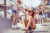 Playful young woman riding skateboard