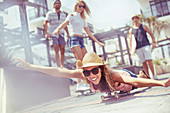 Woman laying riding skateboard