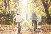 Mother and daughter bike riding on path
