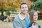 Portrait smiling couple at autumn park