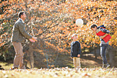 Father and sons playing soccer