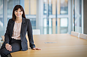Businesswoman leaning on conference table