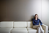 Businesswoman with legs crossed on sofa