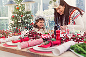 Mother and daughter near Christmas table