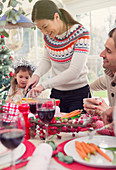 Woman cutting turkey at Christmas table