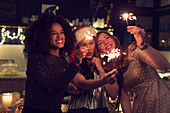 Playful young women with sparklers