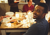 Man enjoying candlelight Christmas dinner