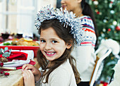 Girl wearing wreath at Christmas dinner