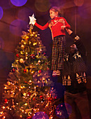 Father and daughter near Christmas tree