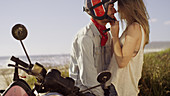 Affectionate young couple at motorcycle