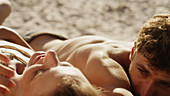 Young couple sunbathing on sunny beach