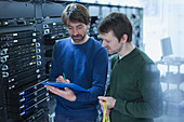 Server room technicians with clipboard