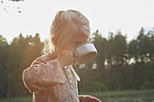 Girl drinking from camping cup