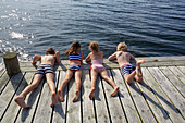 Boys and girls laying on dock
