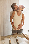 Pregnant couple preparing bubble bath