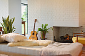 Guitar leaning near fireplace
