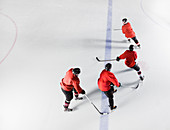 Hockey team in red uniforms skating