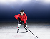 Hockey player in red uniform on ice