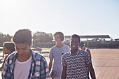 Teenage friends at sunny skate park
