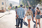 Teenage friends with skateboards walking