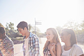 Teenage friends hanging out at sunny park