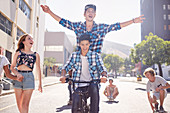 Friends riding BMX bicycle and skateboard