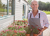 Plant nursery owner with potted flowers