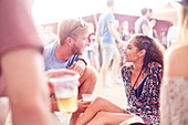 Couple drinking beer at music festival
