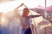 Young woman dancing at music festival