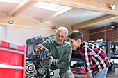 Father and son rebuilding engine