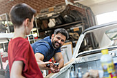 Father and son in auto repair shop