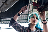 Female mechanic fixing car