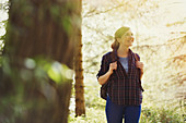 Smiling woman hiking in woods