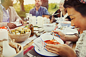 Smiling woman eating soup